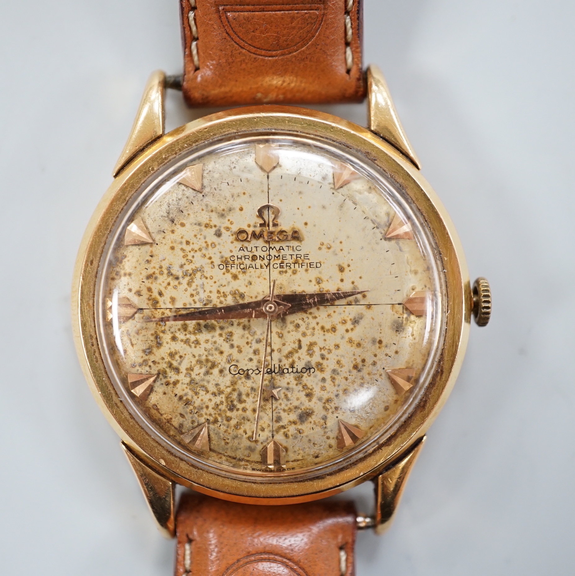 A gentleman's 1950's yellow metal (French 18ct poincon mark) Omega Constellation automatic wrist watch, on associated strap, case diameter 35mm, dial a.f.